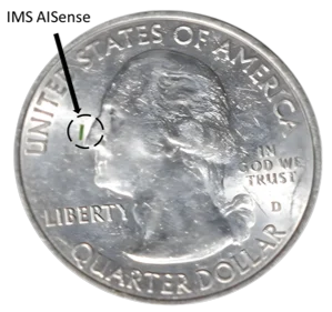 IMS AISense miniature glucose sensor chip shown on a US quarter for scale
